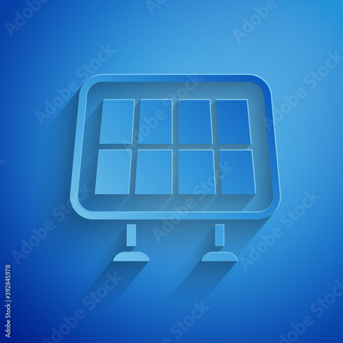 Paper cut Solar energy panel icon isolated on blue background. Paper art style. Vector.