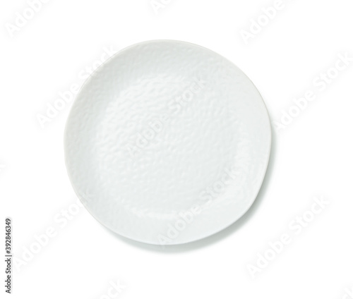 empty white round plate with jagged edges isolated on white background