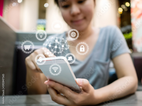 Young woman smiling and using smartphone with icon technology artificial intelligence (AI) and internet of things (IOT)