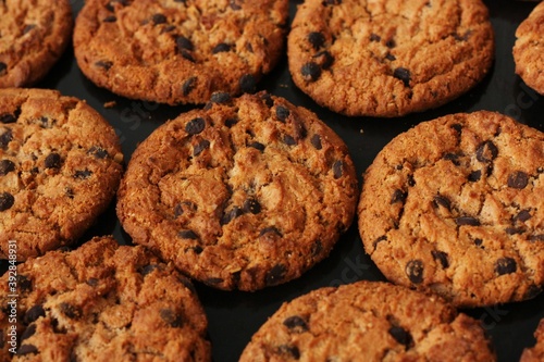 Delicious oatmeal cookies with chocolate on the table