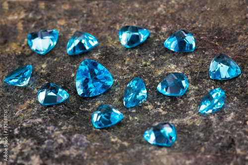 a scattering of beautiful blue topaz on a natural wild stone