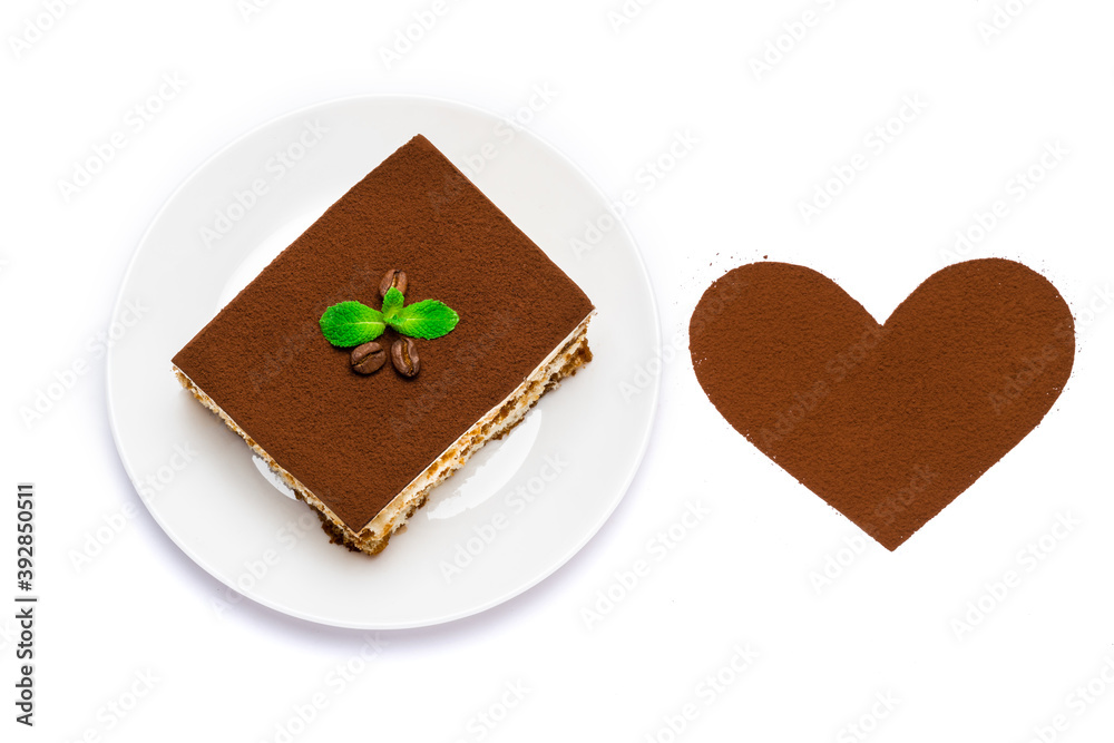 Traditional Italian Tiramisu square dessert portion on ceramic plate and heart shape made of cocoa powder isolated on white Traditional Italian Tiramisu square dessert portion on ceramic plate and heart shape made of cocoa powder isolated on white
