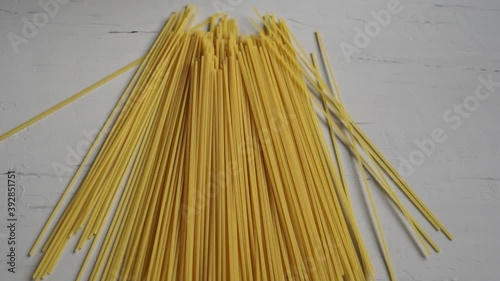 Man show raw spaghetti. Spaghetti in hands
