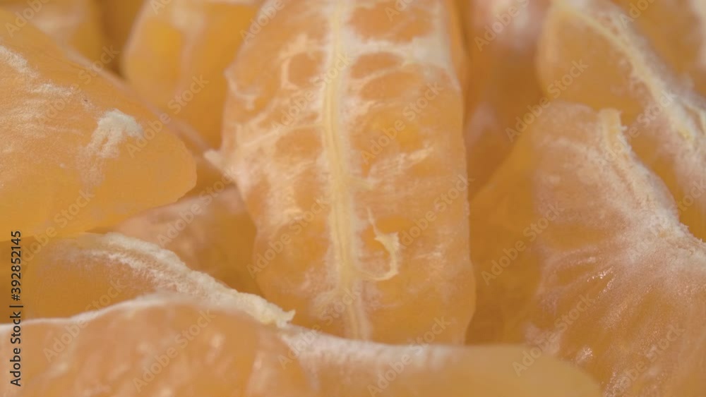 Mandarin slices close-up. Ripe and juicy parts of the fruit. Mandarin slices close-up. Ripe and juicy parts of the fruit.
