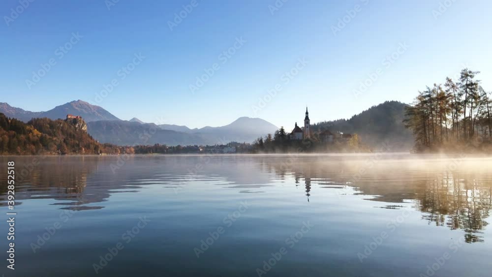 Beautiful video of Bled lake landscape with view to the Castle of Bled and Church of Saint Martin at autumn morning, Slovenia. Beautiful video of Bled lake landscape with view to the Castle of Bled and Church of Saint Martin at autumn morning, Slovenia.