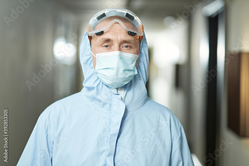 Professional male worker posing in protective clothing