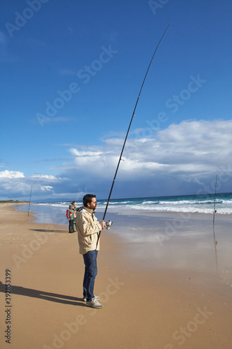 photograph of a fisherman on the beach