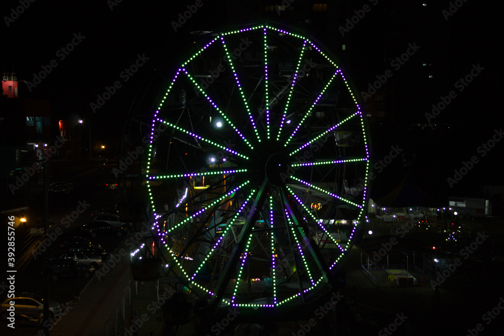 Illuminated ferris wheel in an amusement park