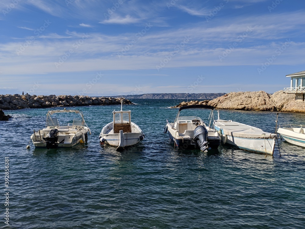 Fototapeta premium Bateau sur la mer, petite barque de pêcheur, quartier de la corniche à Marseille région sud, sous le soleil de l'hiver, vague de la mer méditerranée , ciel bleu, carte postale , beauté de la nature