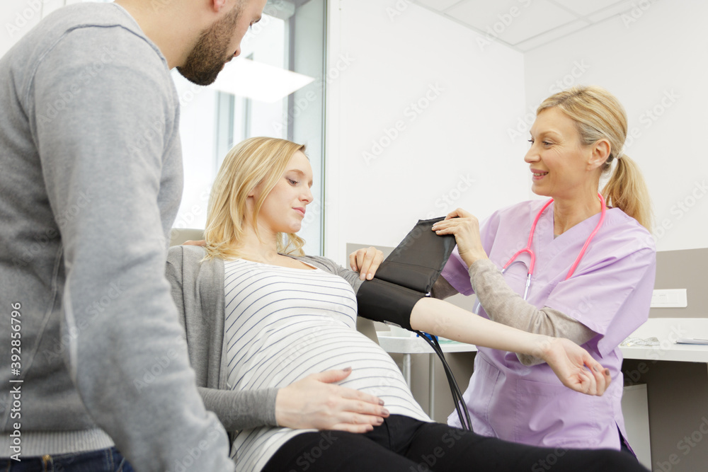 pregnant woman getting her pulse checked pregnant woman getting her pulse checked