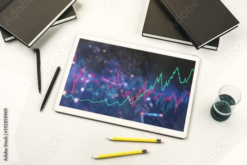 Digital tablet with abstract financial graph, finance and trading concept. Top view. 3D Rendering