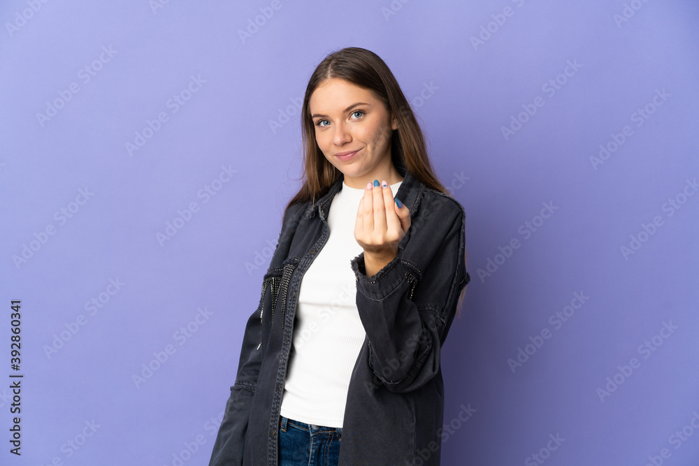 Young Lithuanian woman isolated on purple background inviting to come with hand. Happy that you came Young Lithuanian woman isolated on purple background inviting to come with hand. Happy that you came