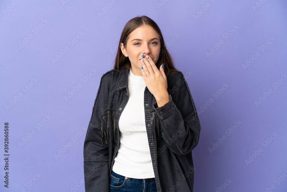 Young Lithuanian woman isolated on purple background happy and smiling covering mouth with hand Young Lithuanian woman isolated on purple background happy and smiling covering mouth with hand