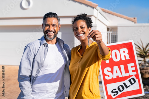 Ethnic couple holding new house keys