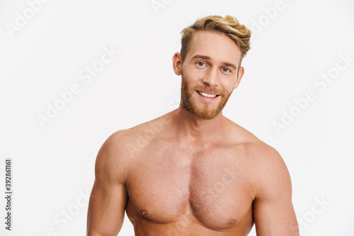 Happy caucasian shirtless man posing and smiling at camera
