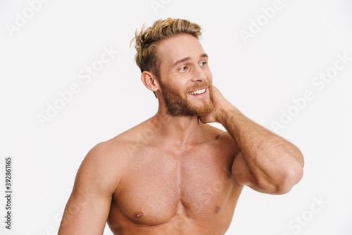 Happy caucasian shirtless man posing and smiling at camera