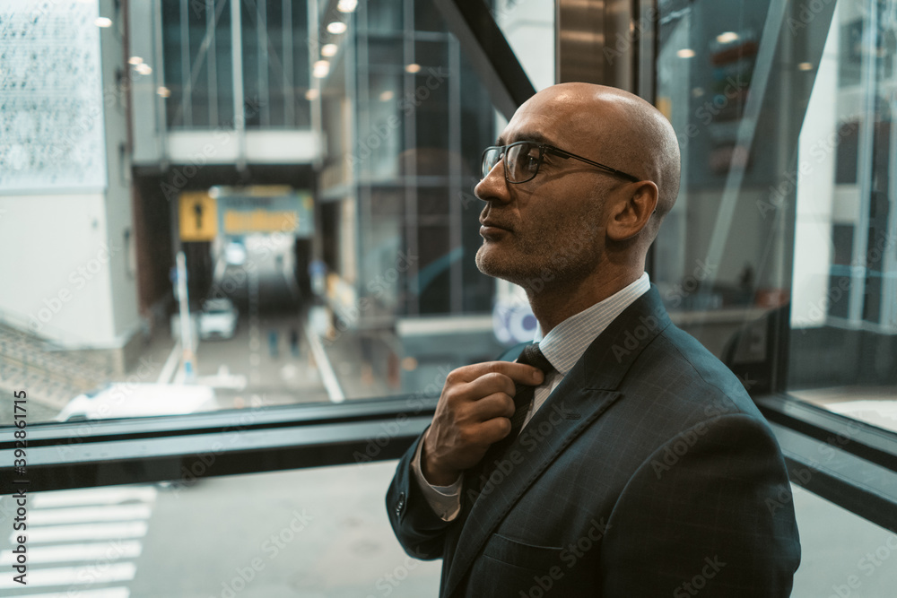 Confident man straightens his tie before good deal. Caucasian businessman in business center. Business concept. Close up shot. Confident man straightens his tie before good deal. Caucasian businessman in business center. Business concept. Close up shot.