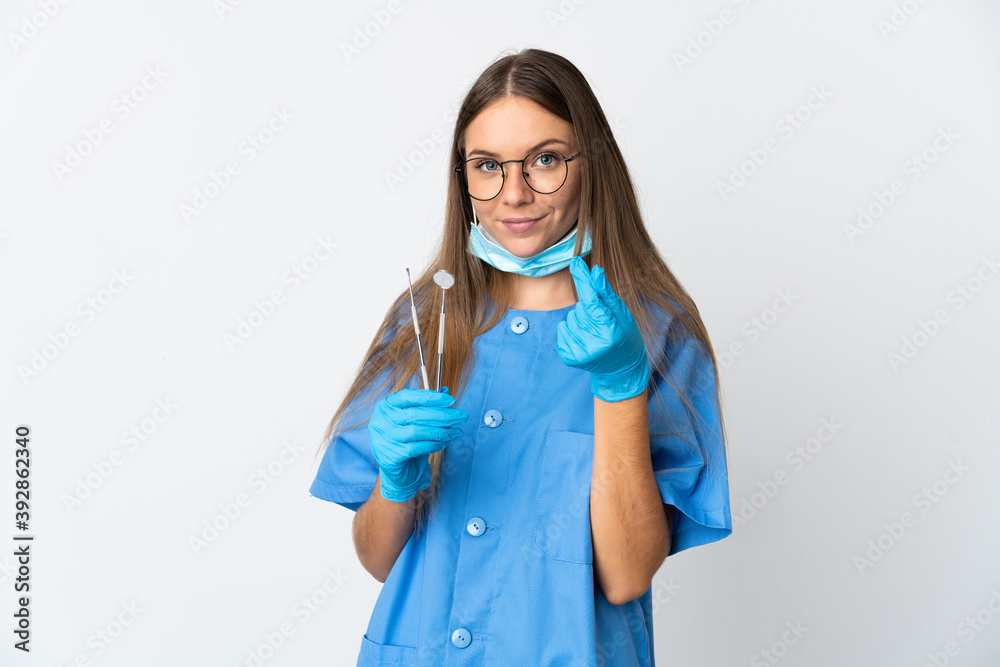 Lithuanian woman dentist holding tools over isolated background making money gesture Lithuanian woman dentist holding tools over isolated background making money gesture