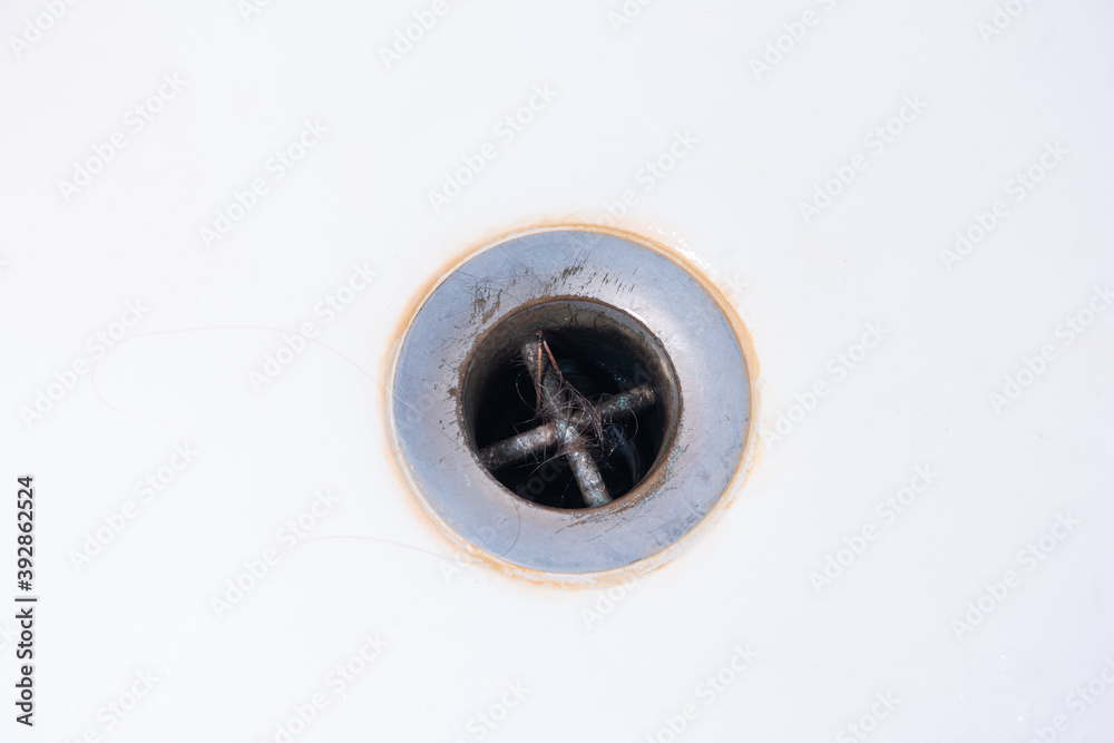 Hair clogged bathtub drain sink close up shot top view Stock Photo