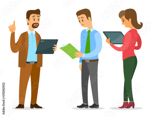 Businessmen are standing with folders and clipboards in their hands and talking, woman looking at the screen of tablet. Office workers discussing. Business meeting and consideration of working issues