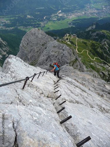 Hiker at mountain Alpspitze via ferrata in Garmisch-Partenkirchen, Bavaria, Germany