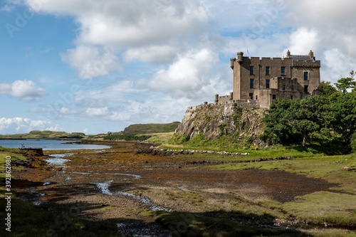 Dunvegan Castle on a top a hill at Isle of Skye  Scotland during the low tide with blue sky