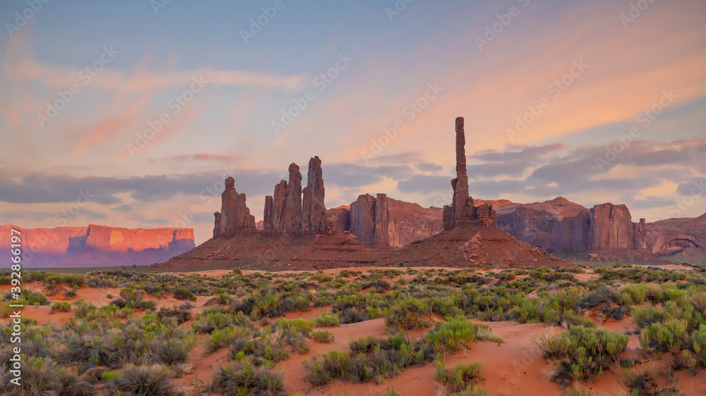 Totem pole and sand dunes  in Monument Valley, Arizona USA
