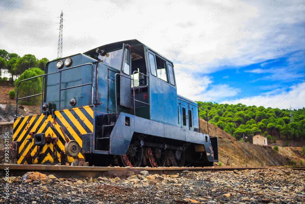 abandoned locomotive and train tracks