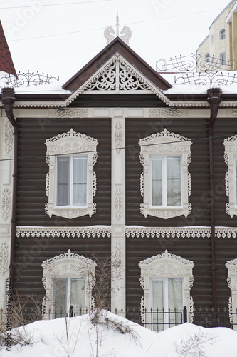Vintage wooden house with carved windows in Krasnoarmeyskaya Street, 12a, Tomsk city, Russia. Russian folk style in architecture. Tomsk view. Tomsk landmark, monument photo
