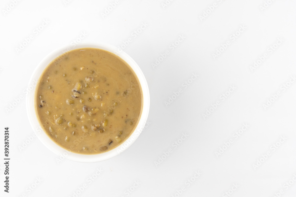 Mung beans porridge (bubur kacang hijau) is a Malaysian traditional dish usually eat as starter or desert. Made from mung beans, coconut milk & palm sugar. Isolated over white background. Mung beans porridge (bubur kacang hijau) is a Malaysian traditional dish usually eat as starter or desert. Made from mung beans, coconut milk & palm sugar. Isolated over white background.