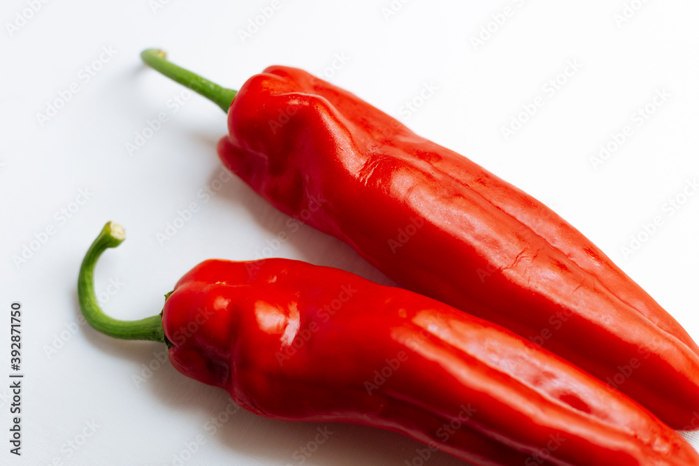 Fresh red pepper on white background.Two red sweet bell peppers on white background. 