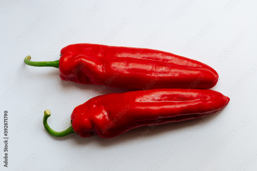 Fresh red pepper on white background.Two red sweet bell peppers on white background. 