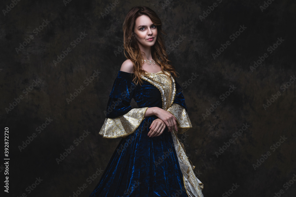 Beautiful woman in renaissance dress on abstract dark background