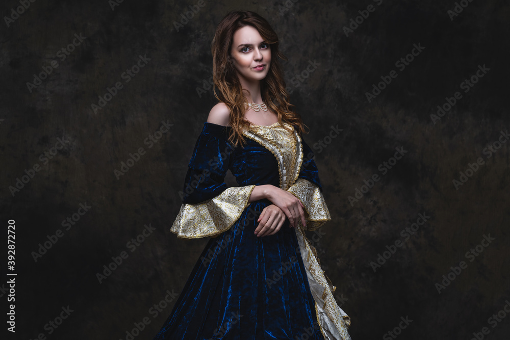 Beautiful woman in renaissance dress on abstract dark background Beautiful woman in renaissance dress on abstract dark background