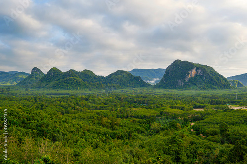 Mountains green forest in aerial view. Landscape beautiful blue sky with fluffy white clouds in a day.