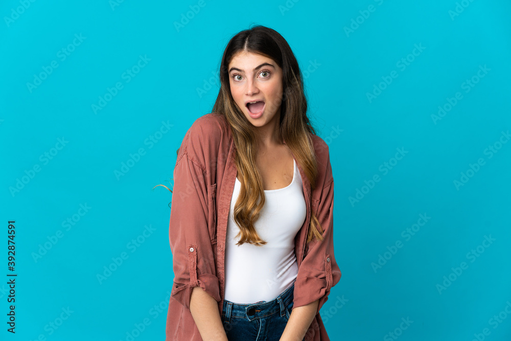 Young caucasian woman isolated on blue background with surprise facial expression Young caucasian woman isolated on blue background with surprise facial expression