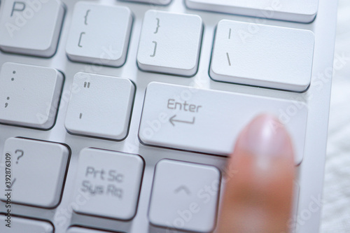 Hands of business woman Pressing enter button on computer keyboard