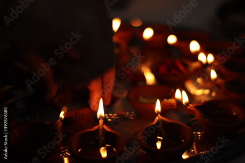 Lighting Diyas/Earthern Lamps during Diwali 