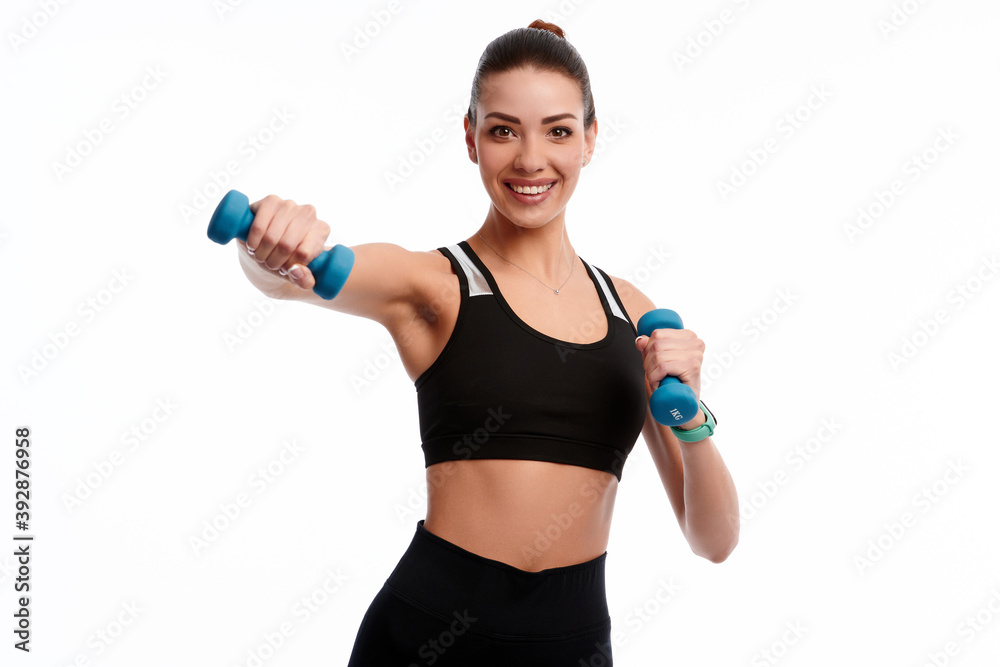 Attractive caucasian slim woman doing physical exercise using dumbbell isolated on white background Attractive caucasian slim woman doing physical exercise using dumbbell isolated on white background