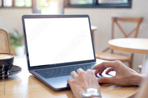 computer blank screen mockup.hand woman work using laptop with white background for advertising,contact business search information on desk at coffee shop.marketing and creative design.