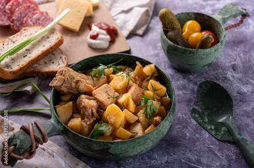 Potatoes with meat and herbs. Meat and cheese cuts. Dinner setting. photo