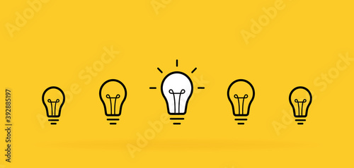 Creative idea. Set of standing light bulbs. Light with rays isolated on yellow background. Vector illustration