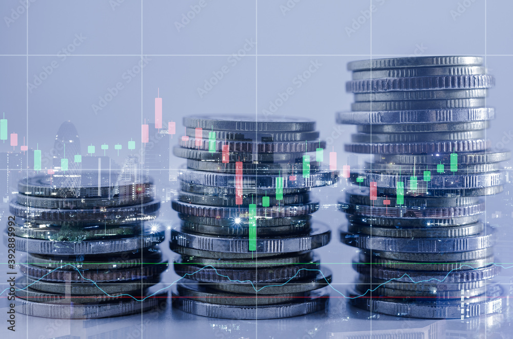 double exposure of city with row of coin stack with growth stock chart and graph progress report for business investment finance banking and money saving concept.