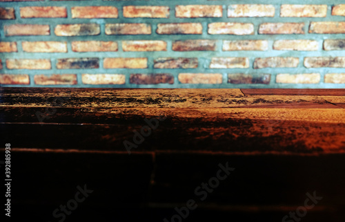 Empty top of wooden table or counter isolated on rustic brick Texture background. For product display