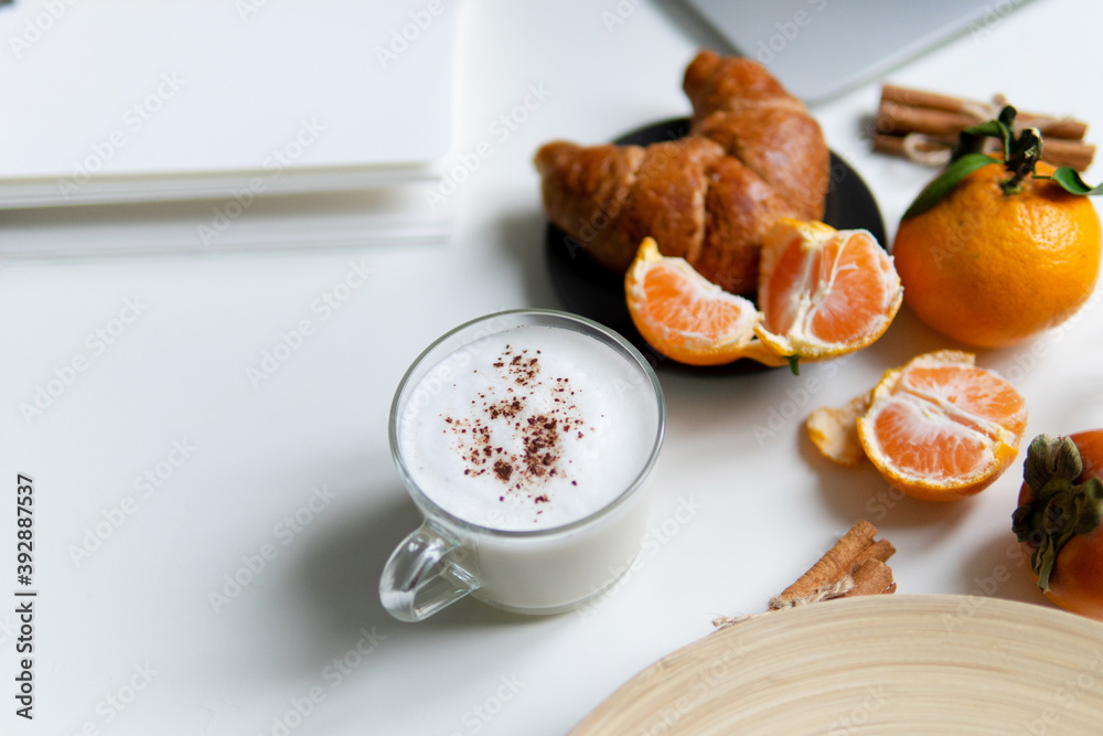 Composition with New Year's assortments on a white table. Christmas mood. over white background coffee croissant tangerines and cinnamon. Place for inscription layout. Flat lay Composition with New Year's assortments on a white table. Christmas mood. over white background coffee croissant tangerines and cinnamon. Place for inscription layout. Flat lay
