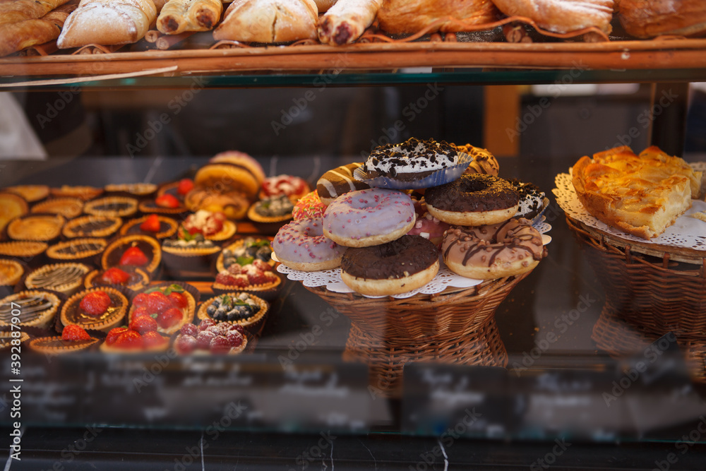 Retail display at the bakery full of delicious donuts and tertelettes