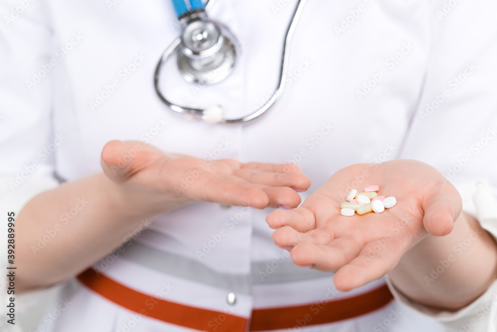 Photo of doctor with drugs in hands on light background Photo of doctor with drugs in hands on light background