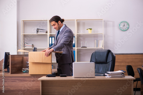 Young male employee being dismissed from his work