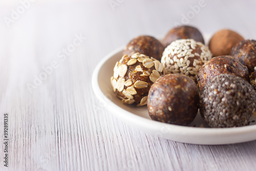 Raw vegan healthy energy balls with oatmeal, chia seed, coconut flakes, cocoa and dried fruits. No cook energy bites.