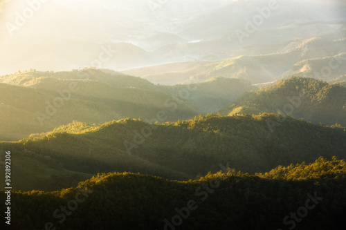 Landscape of mountain with haze in morning with sunlight.